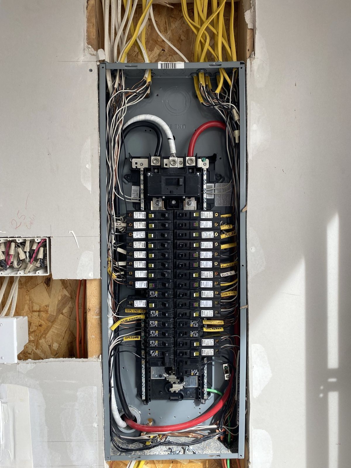 The same panel wired: every circuit landed on its breaker, cables dressed and labeled